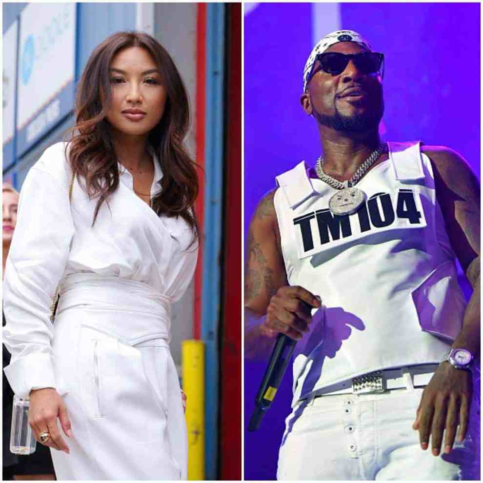 Jeannie Mai is seen wearing white jumpsuit with transparent purse and cheetah print pumps in front of Pier59 Studios during New