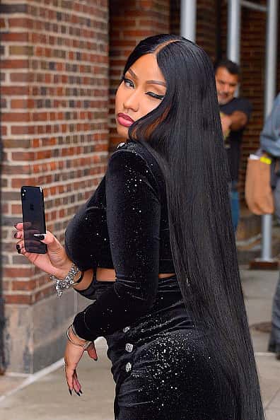 Nicki Minaj in black velvet dress taking selfie