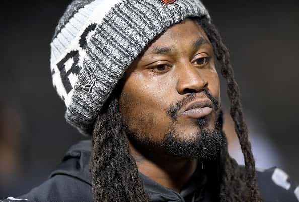 Marshawn Lynch #24 of the Oakland Raiders looks on from the sidelines against the Detroit Lions