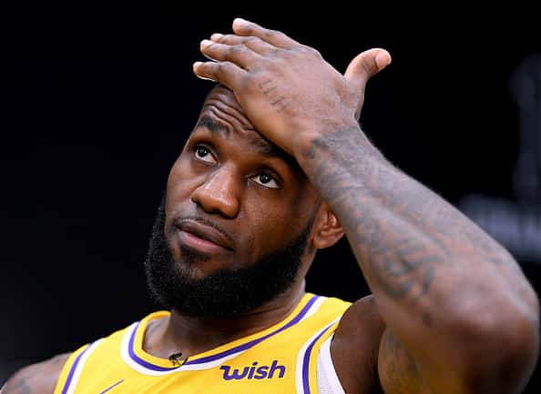 LeBron James with hand to forehead during a game