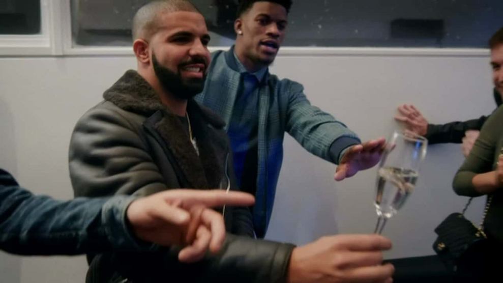 Drake holding champagne glass