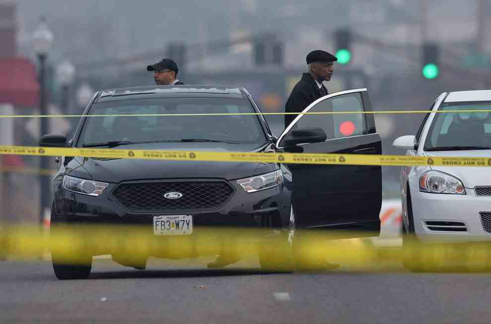 Man exiting car behind police tape