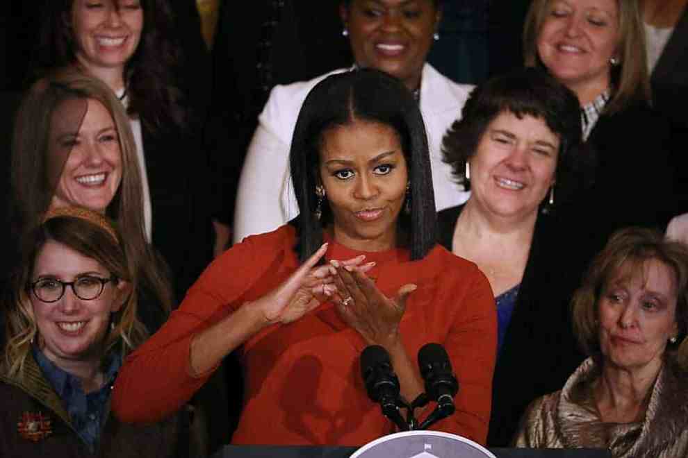Michelle Obama clapping while giving speech