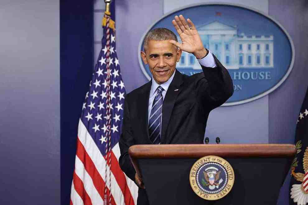 President Barack Obama waving from podium