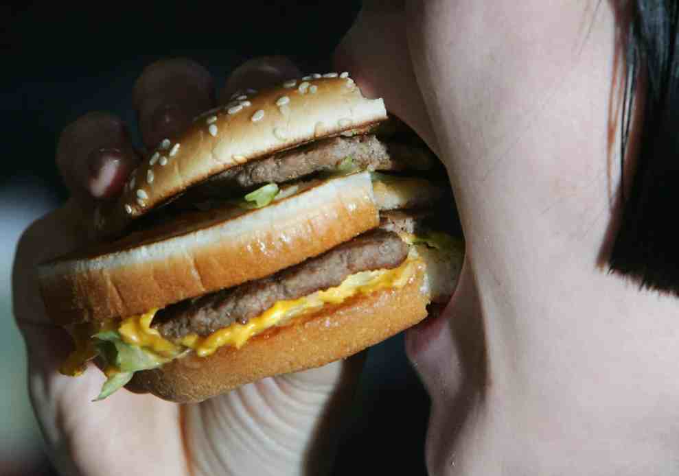 woman eating fast food burger
