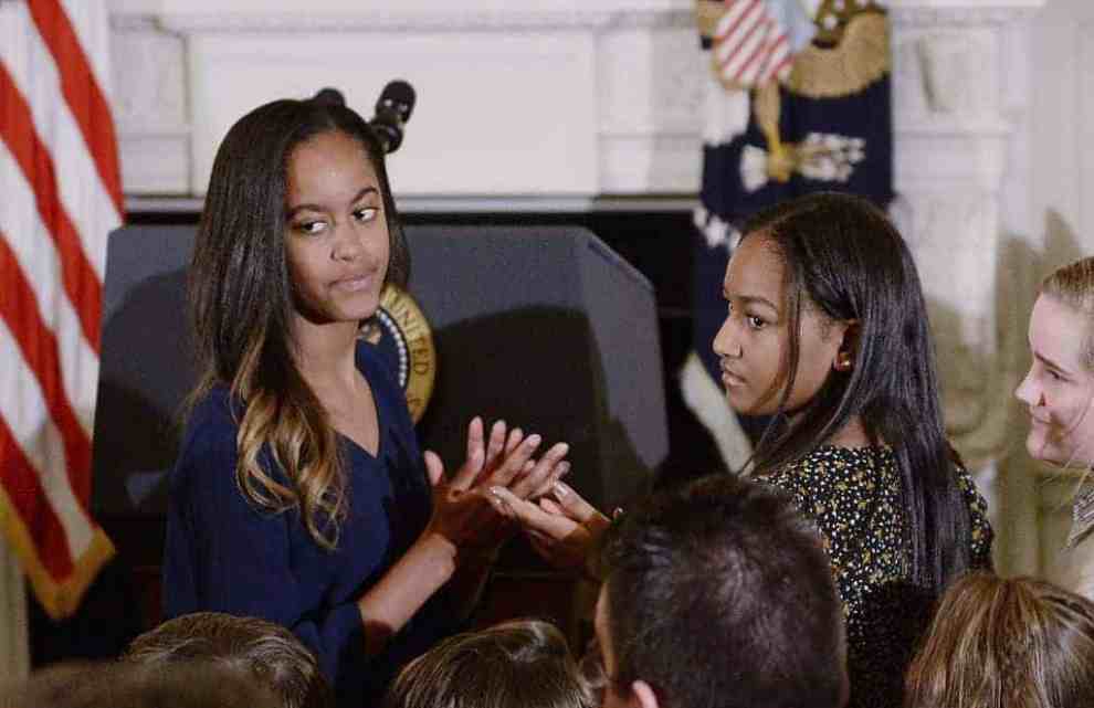 Malia and Sasha Obama in front of podium