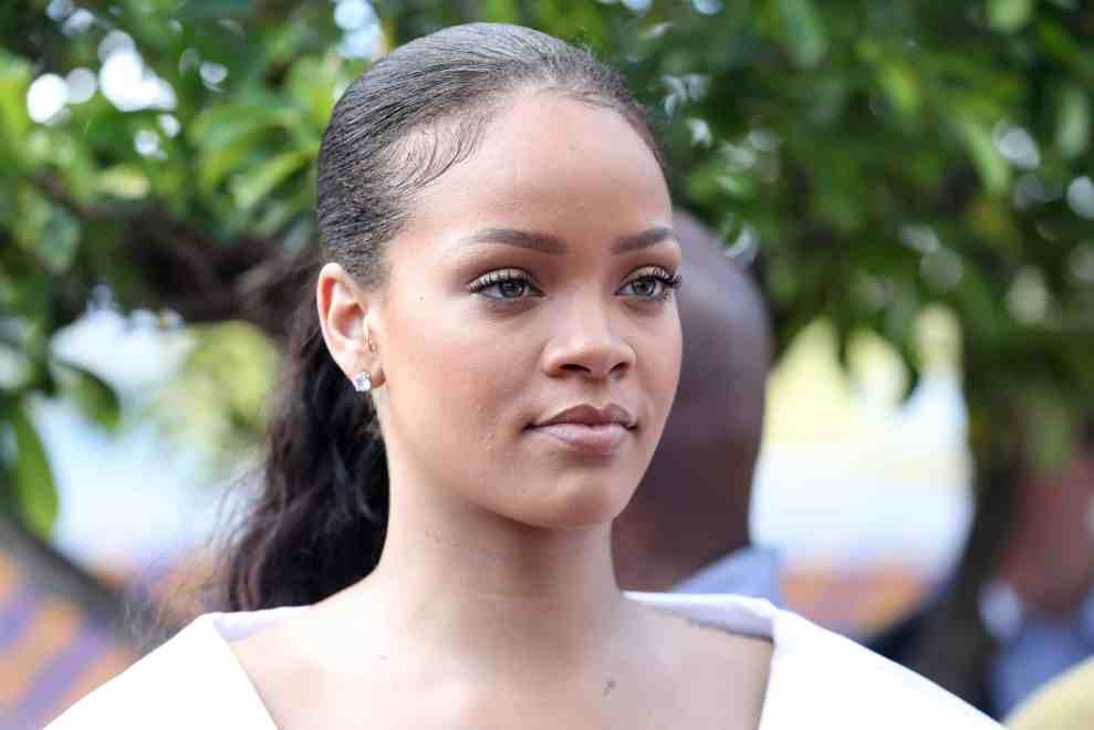 Rihanna outside with ponytail and white shirt