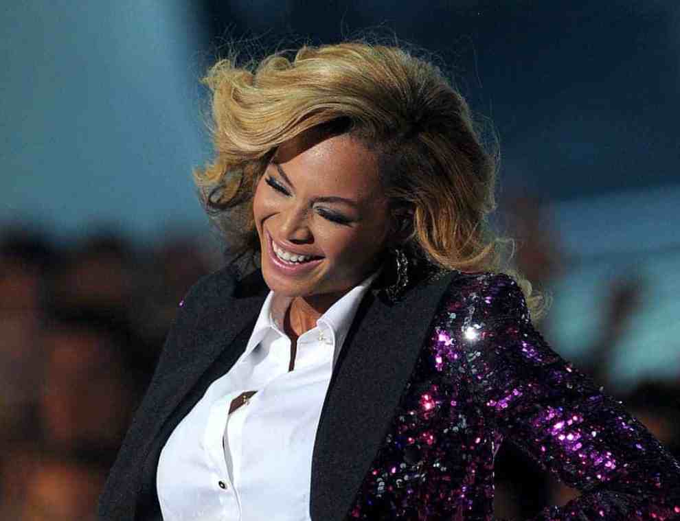 Beyoncé in white blouse and purple sparkly jacket