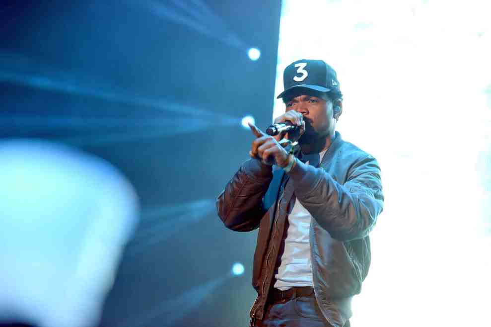Chance the Rapper performing in black baseball cap reading 3