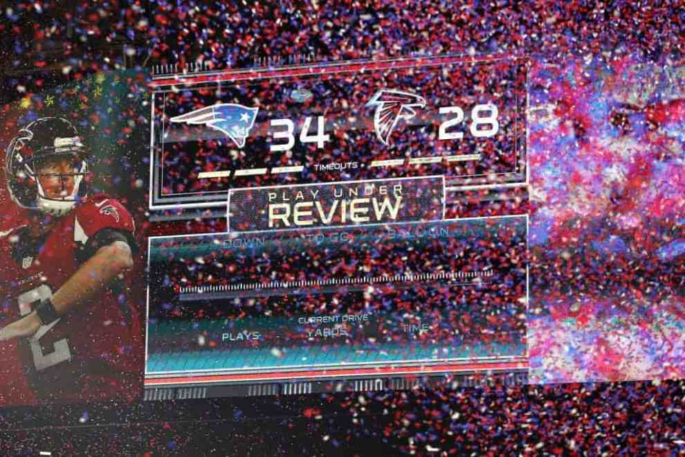 Red and Blue confetti in front of Super Bowl 51 scoreboard showing Patriots 34 Falcons 28