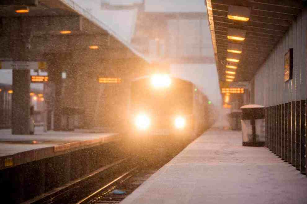 train moving through snowy platform