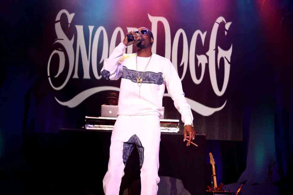 Snoop Dogg performing in front of large Snoop Dogg background