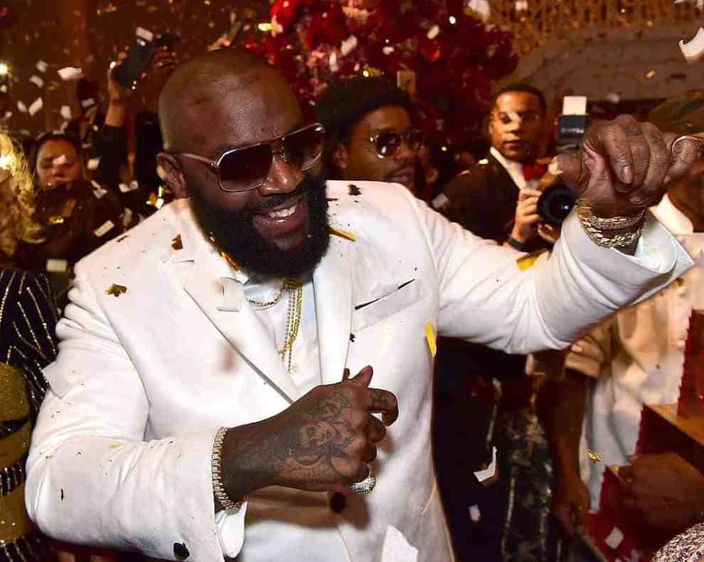 Rick Ross at event with gold confetti