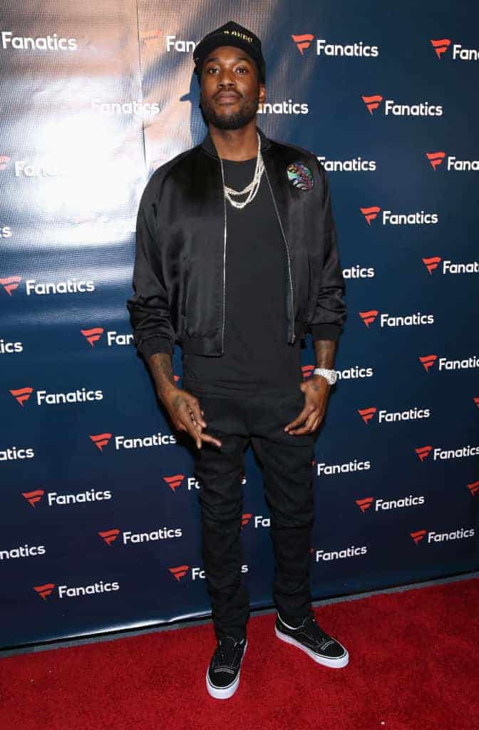 Meek Mill in front of Fanatics backdrop on red carpet