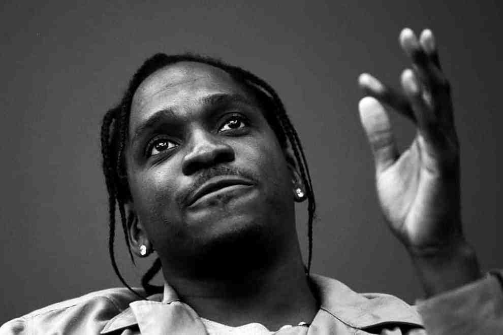 Pusha T gesturing with left hand (in black and white)