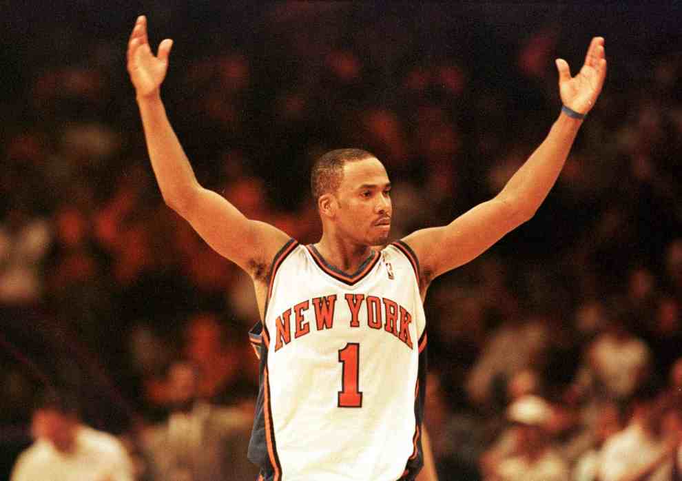 Chris Childs in New York Knicks #1 Jersey with both hands up on the court