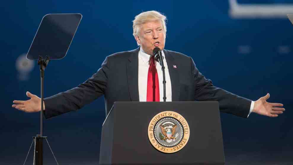 President Trump in front of podium with Seal of the President of the United States