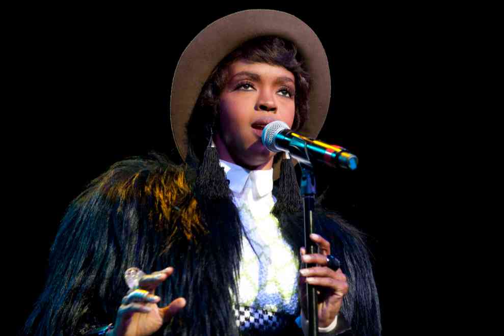 Lauryn Hill performing in fur jacket