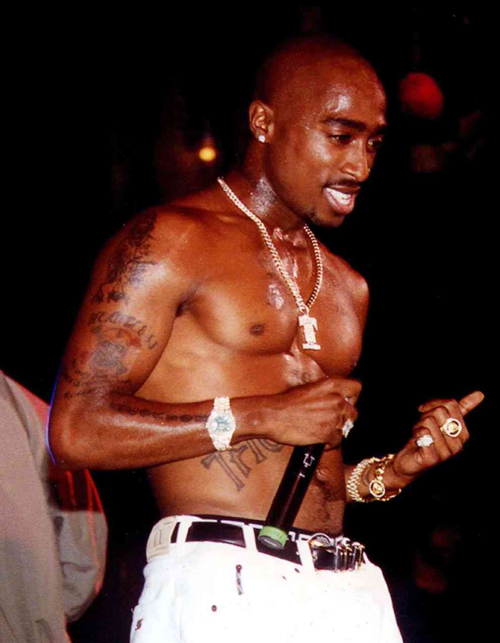 2Pac with microphone performing shirtless