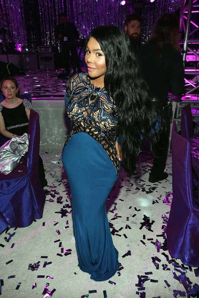 Lil Kim in formal blue dress at an event