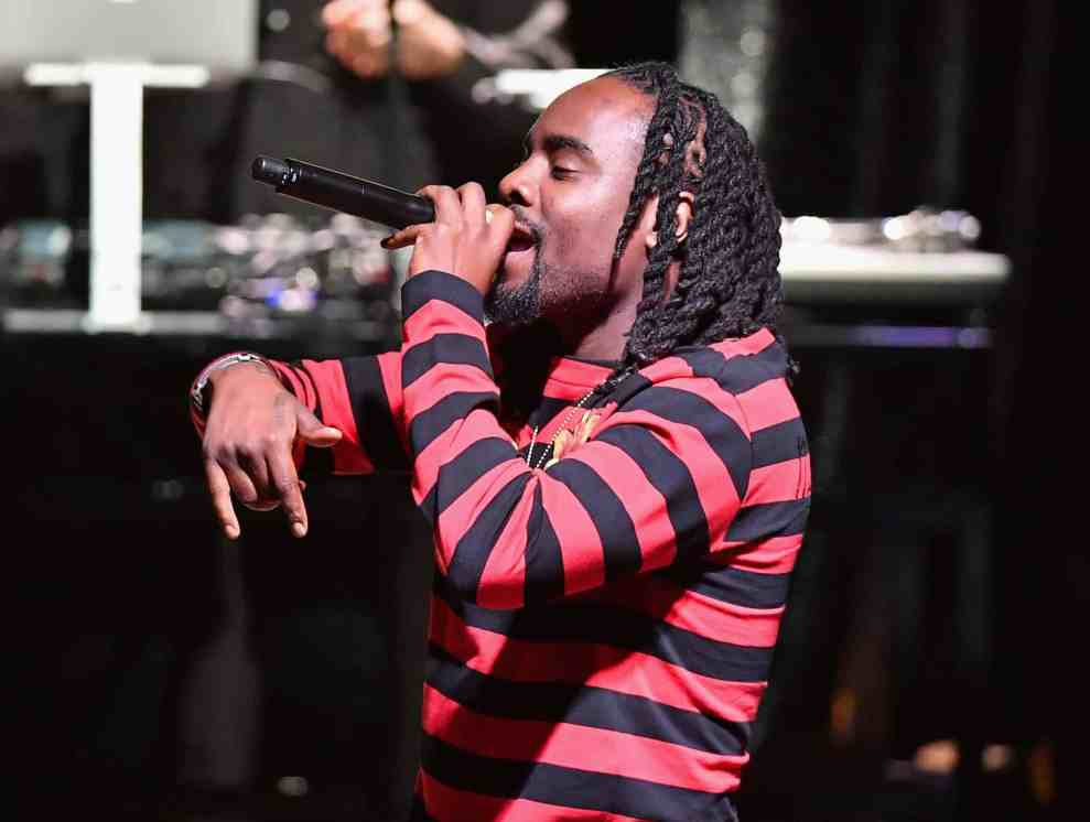 Wale performing in red and black shirt
