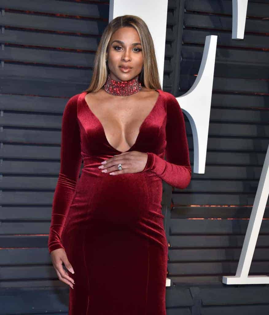 Pregnant Ciara in red velvet low cut dress