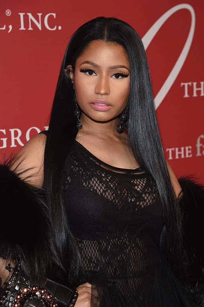 Nicki Minaj in front of red event background