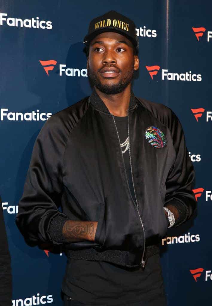 Meek Mill in front of Fanatics backdrop on red carpet