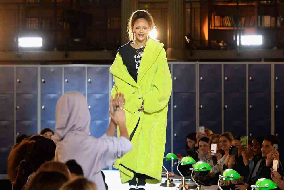 Rihanna in neon yellow long jacket on runway