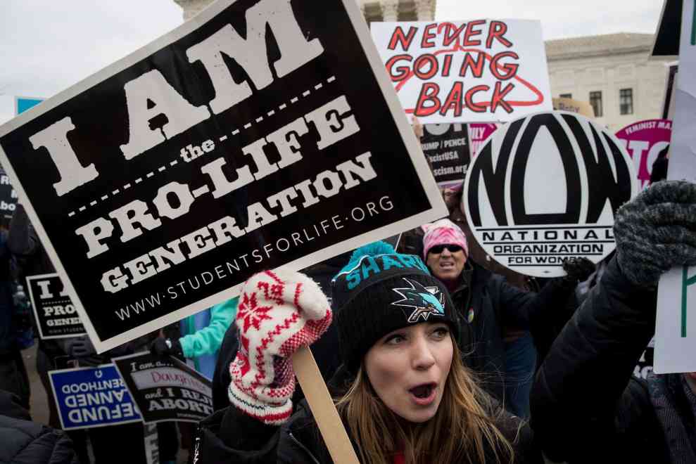 Pro Life protest with women holding signs reading I am the Pro-Life Generation
