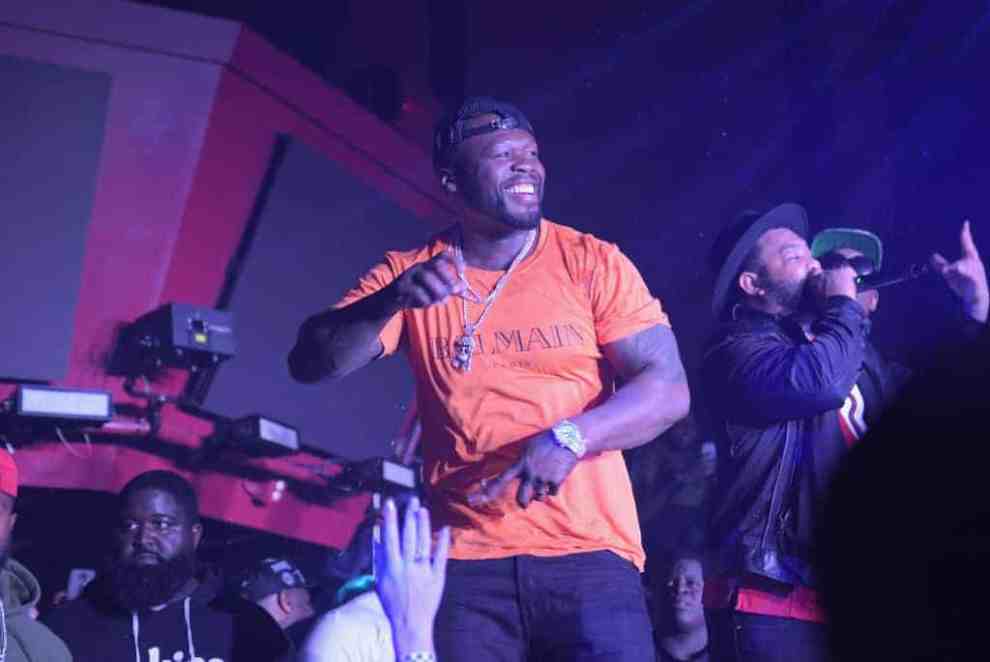 50 Cent performing in orange Balmain Paris t-shirt