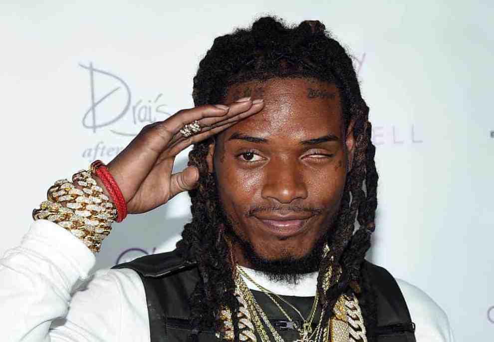 Fetty Wap saluting in front of Drai's background