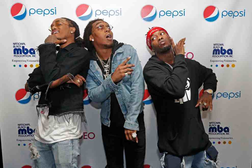 Migos posing on red carpet at National Black MBA Association Inc. Empowering Visionaries event co-sponsored with pepsi