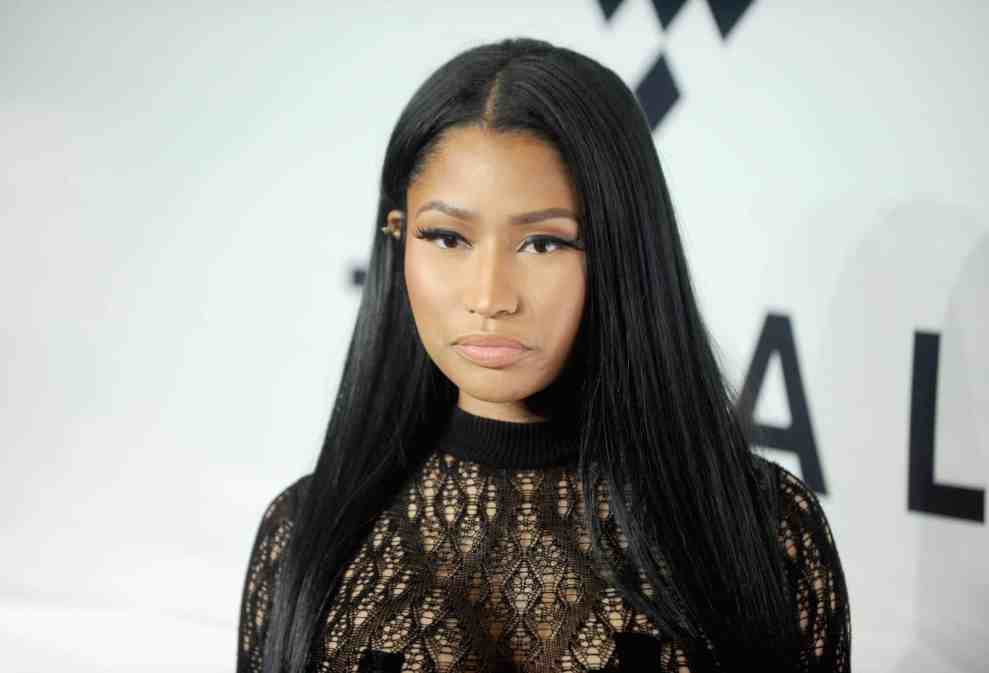 Nicki Minaj in black lace dress in front of white background