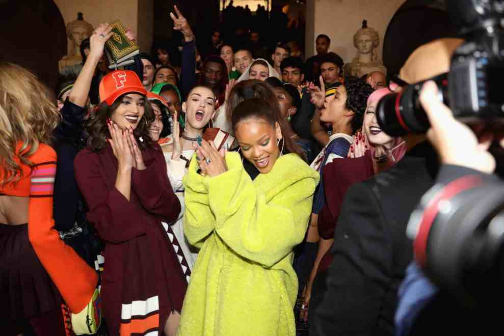 Rihanna in neon yellow long jacket in crowd