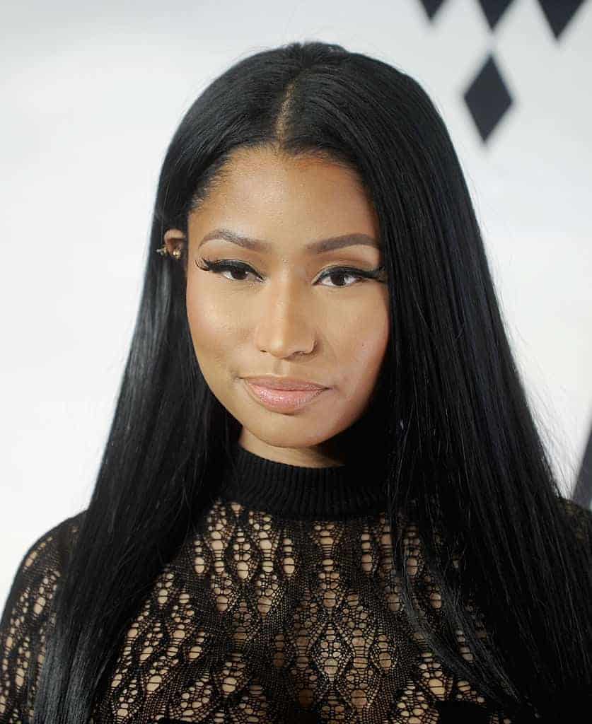 Nicki Minaj in black lace dress in front of white background