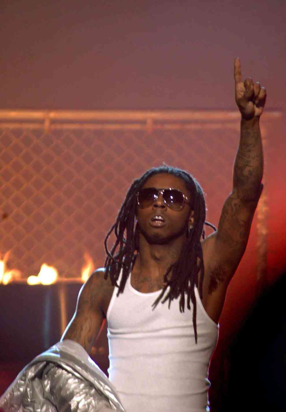 Lil Wayne performing and pointing up with left hand