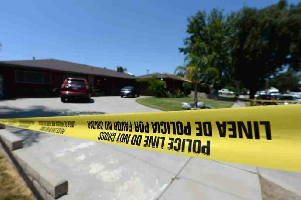 Police Line yellow tape in front of house