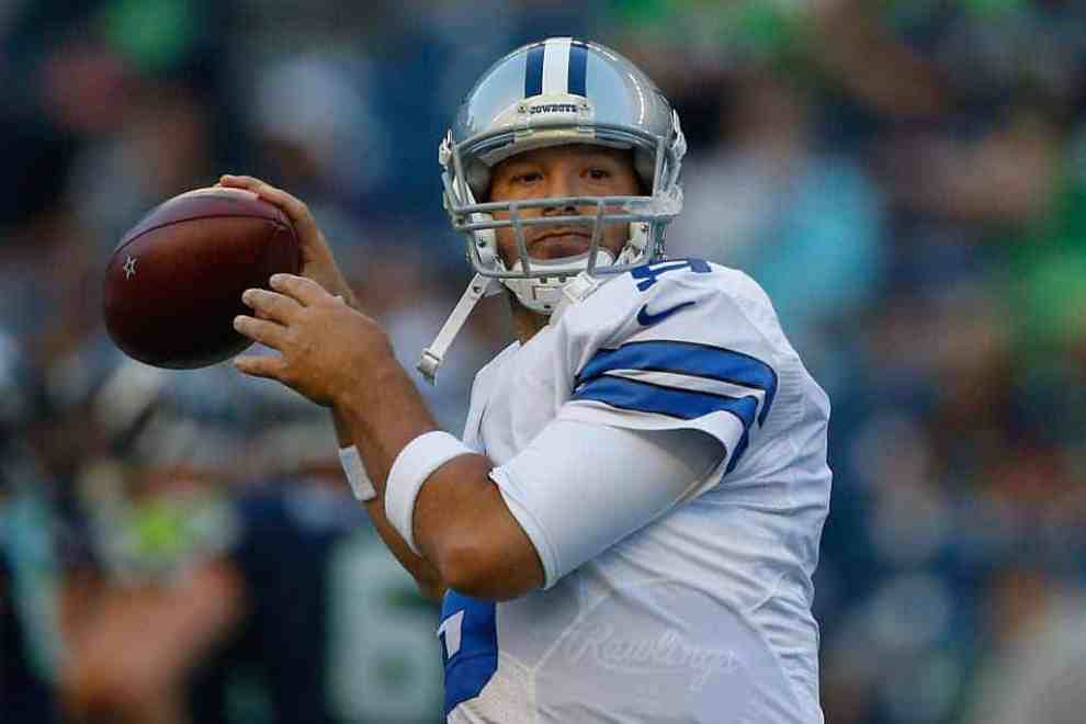 Tony Romo in Cowboys Jersey throwing football during game