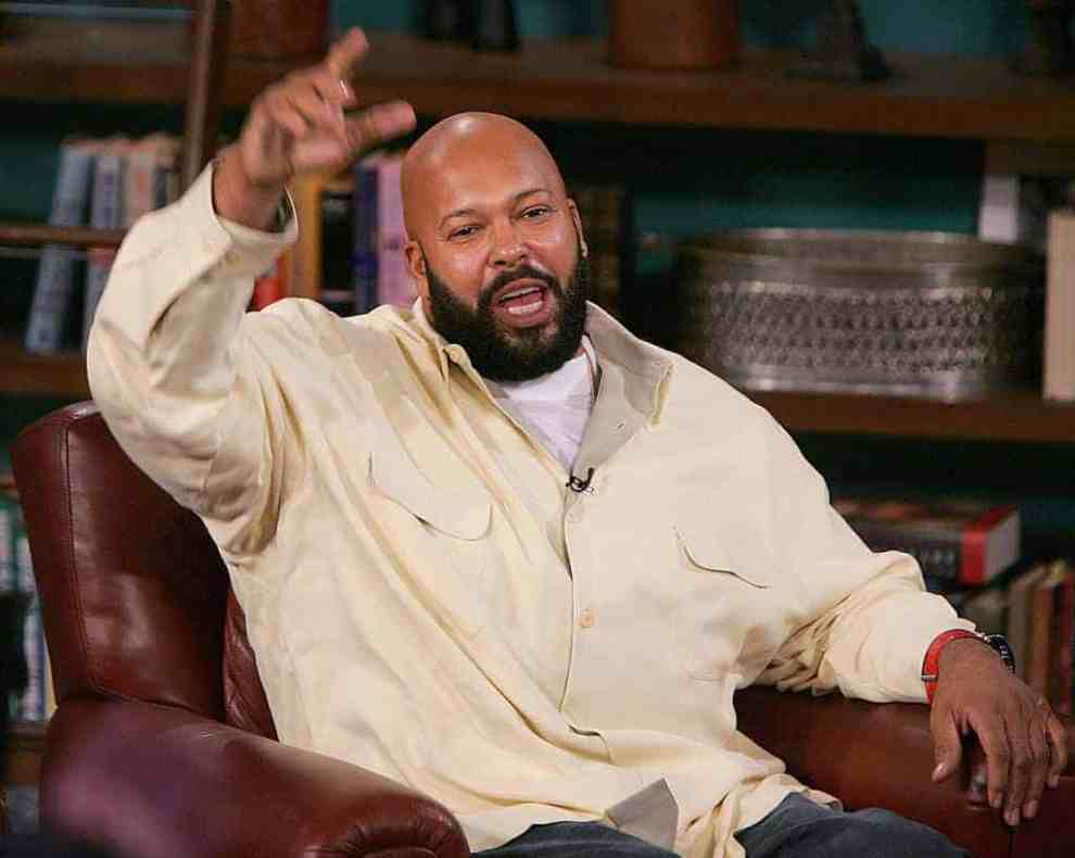 Suge Knight sitting in leather chair in front of bookcase