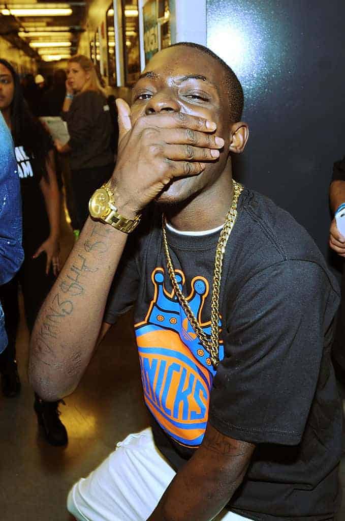 Bobby Shmurda in Knicks t-shirt with hand over mouth