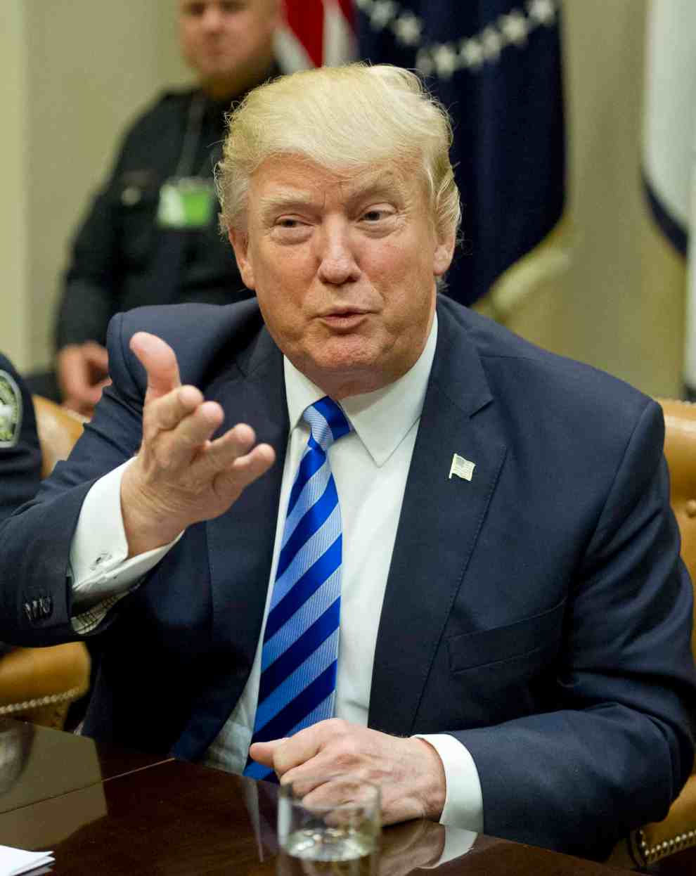 Donald Trump gesturing at podium