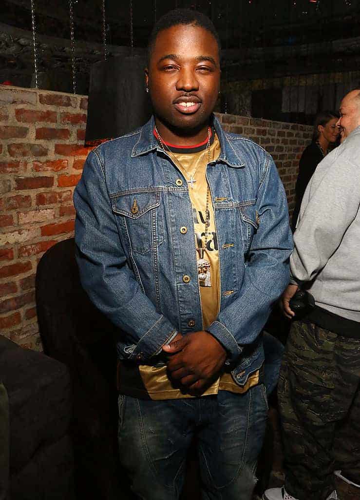 Troy Ave in front of brick background