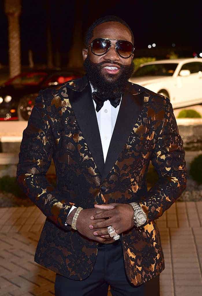 Adrien Broner in gold and black tuxedo jacket