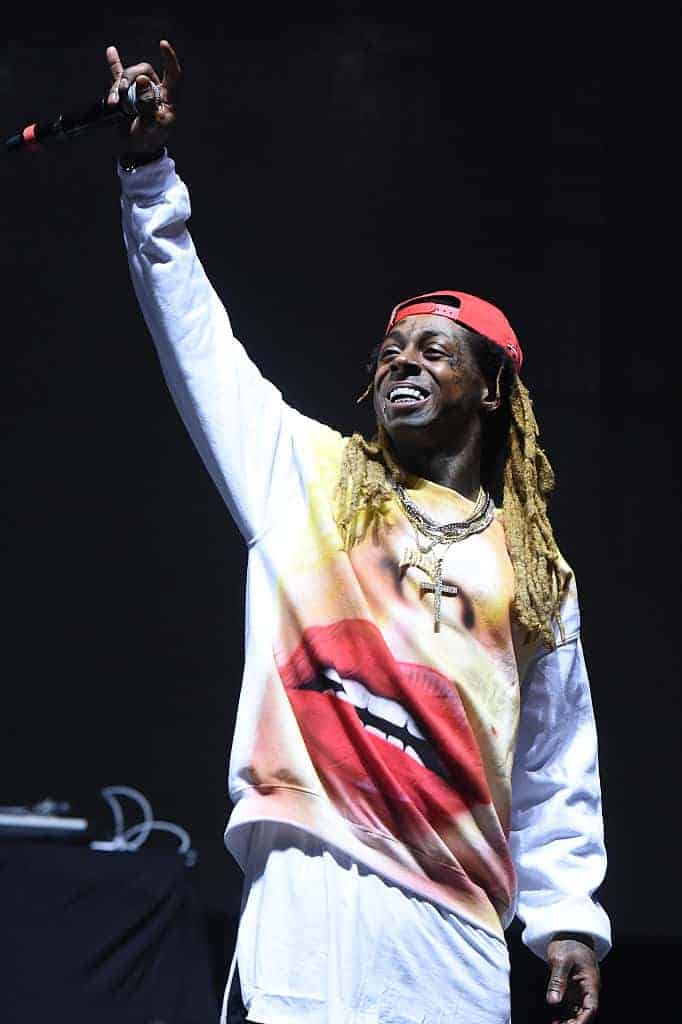 Lil Wayne performing and pointing up with right hand