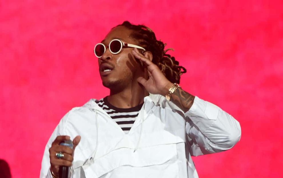 Future performing in round sunglasses agains red background