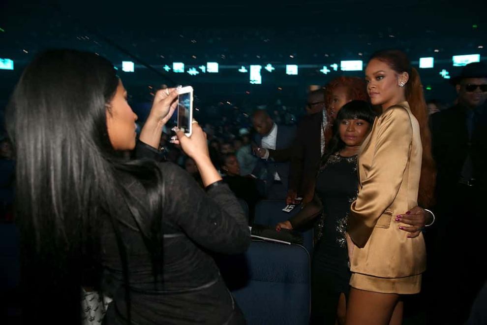 Nicki Minaj taking cell phone picture of Rhianna