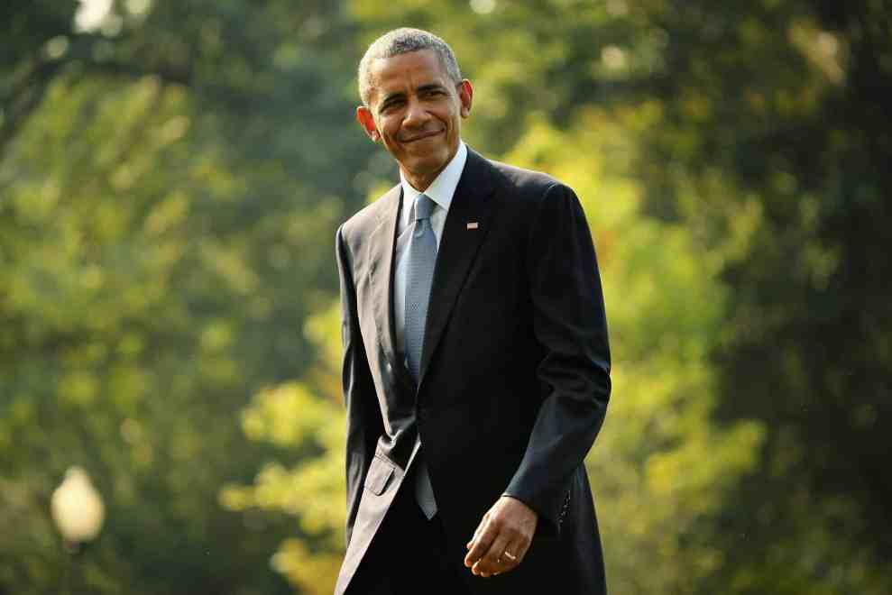 Barack Obama walking in a suit