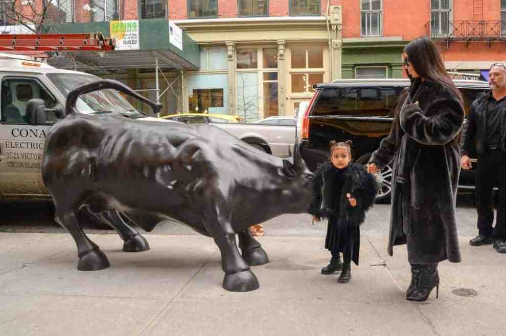 North West and Kim Kardashian in front of Wall Street Bull