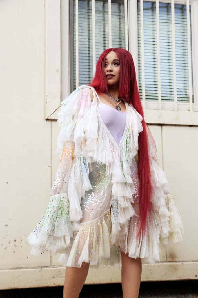Cardi B with long red hair and white dress